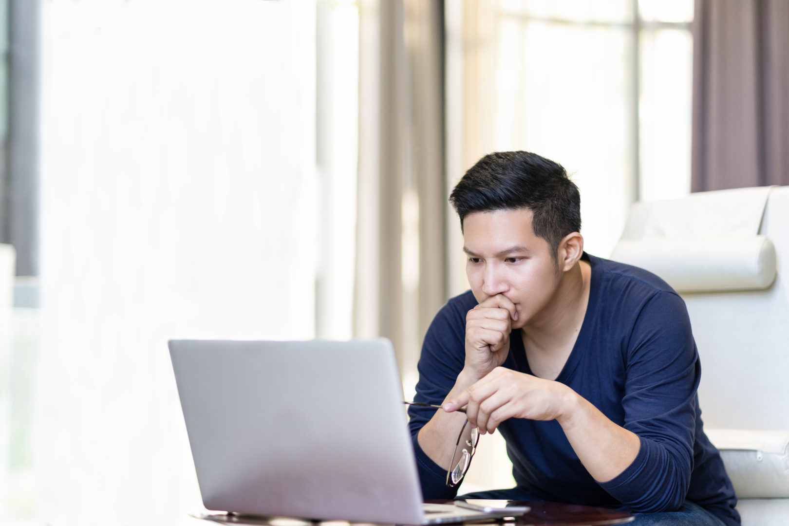 Image of a man working from a laptop